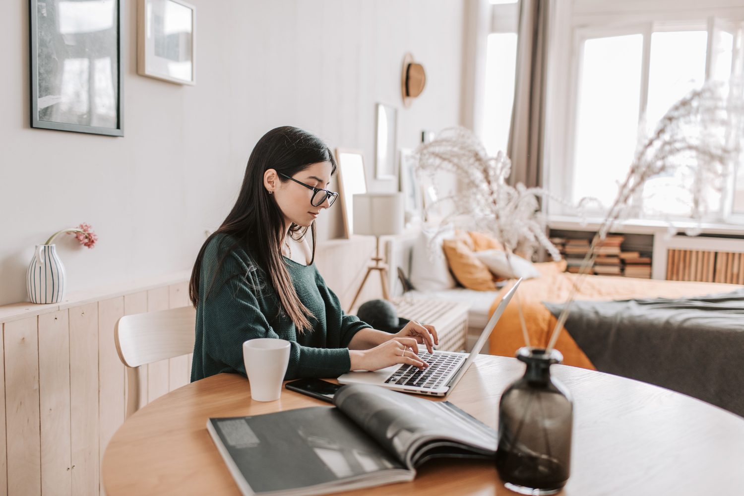A small business owner reviewing her finances on a laptop at home
